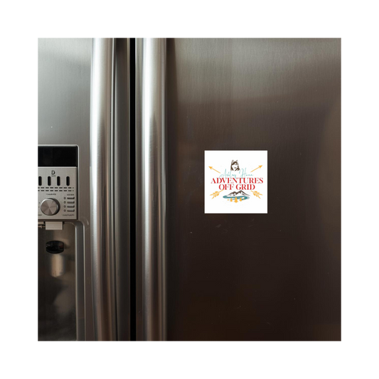 Fridge with a magnet featuring 'Adventures of the Grill' on a white background